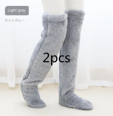 Light gray fuzzy knee-high socks on a white background