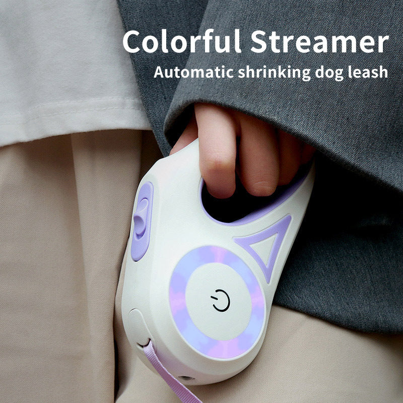 Automatic shrinking dog leash with colorful streamer held by a person