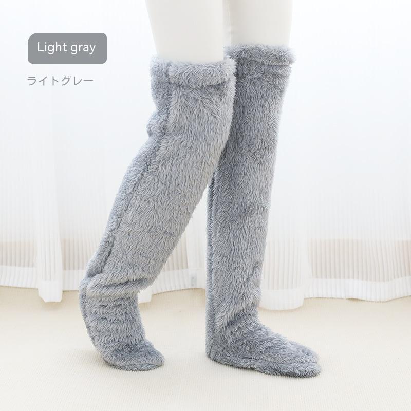 Light gray fuzzy knee-high socks on a white background