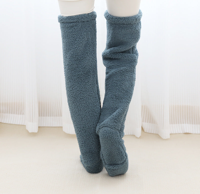 Blue fuzzy knee-high socks on a white background