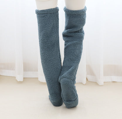 Blue fuzzy knee-high socks on a white background